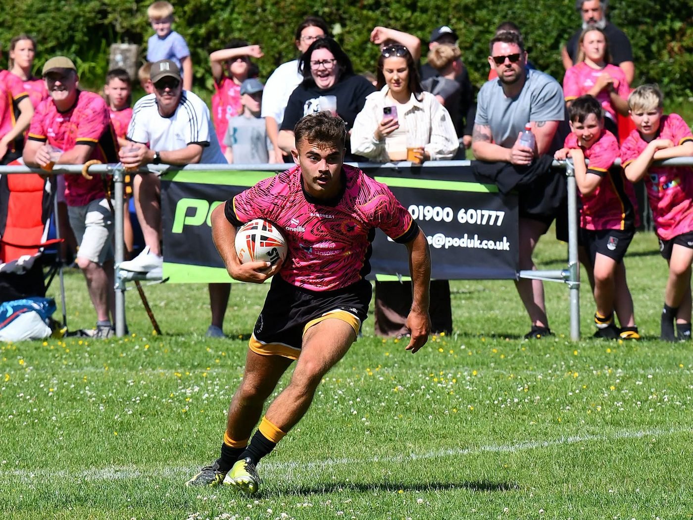 Supporters and pitch-side boards at an Aspatria Hornets matchday