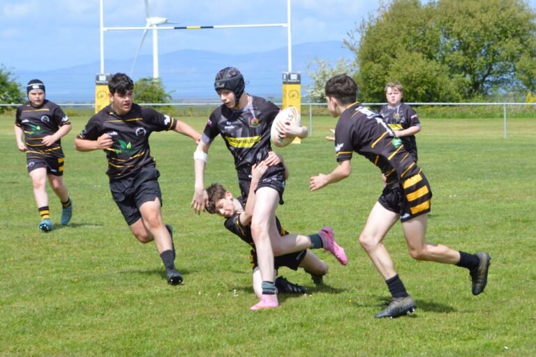 A young Aspatria Hornets player breaking away with the ball
