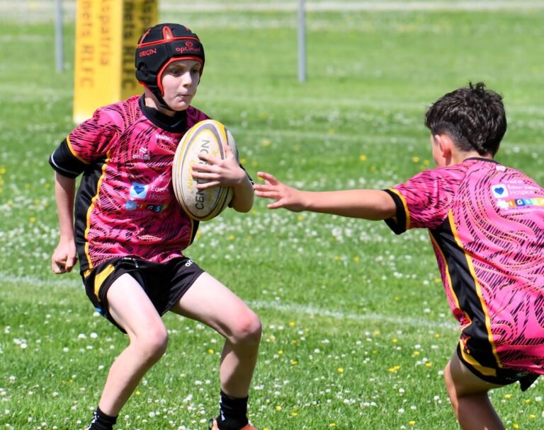 A young Aspatria Hornets player passing the ball wide