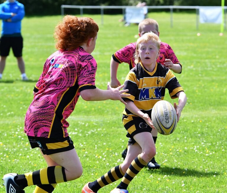 Two young players competing for the ball