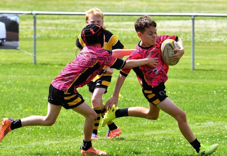 A junior player running clear with the ball in hand