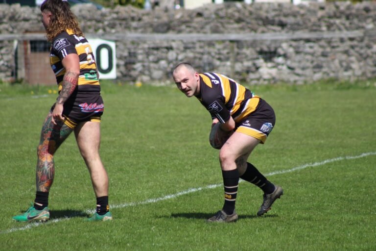 Aspatria Hornets and Millom players chasing the ball downfield