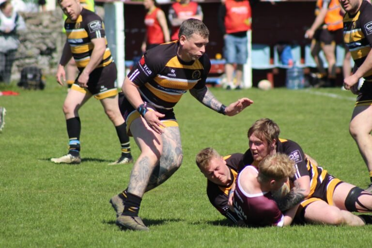 An Aspatria Hornets tackle bringing down a Millom player