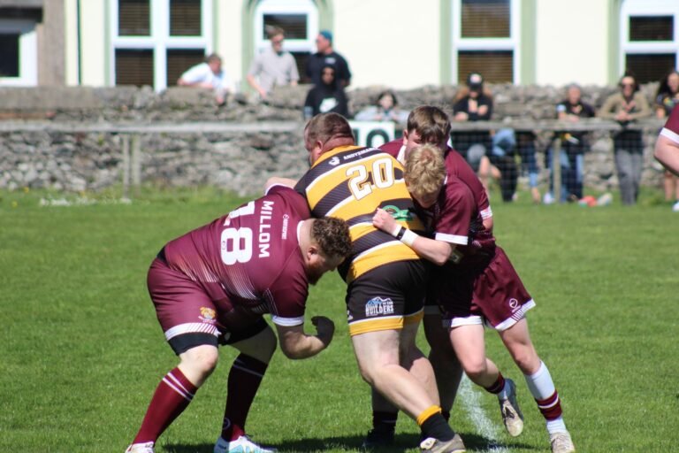 An Aspatria Hornets player wrapped up by the Millom defence