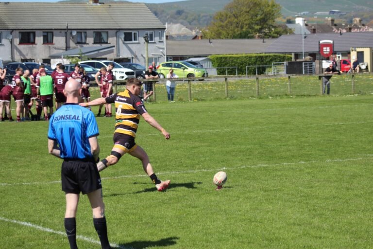 The referee following play during the match against Millom