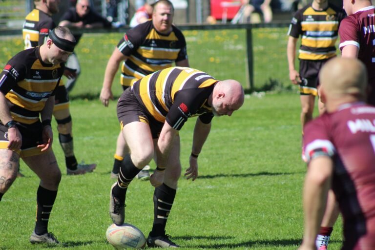 An Aspatria Hornets player working the ball away from the tackle