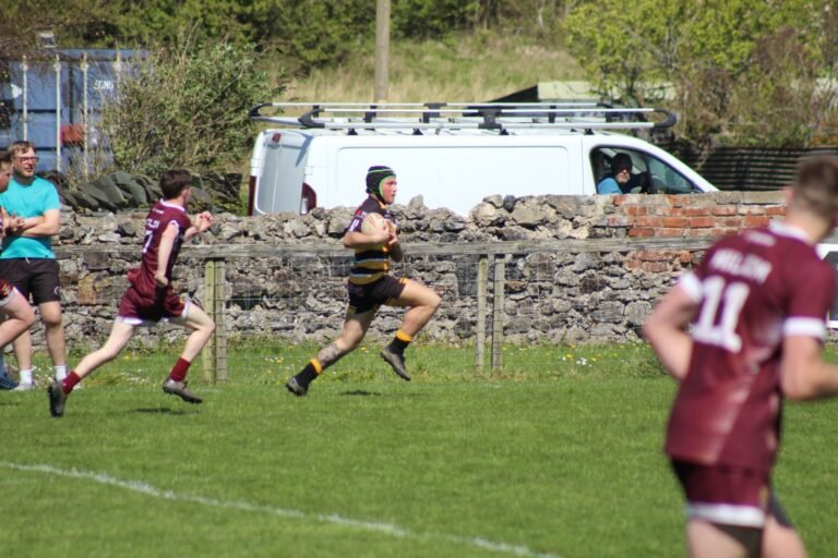 Players chasing back in defence against Millom